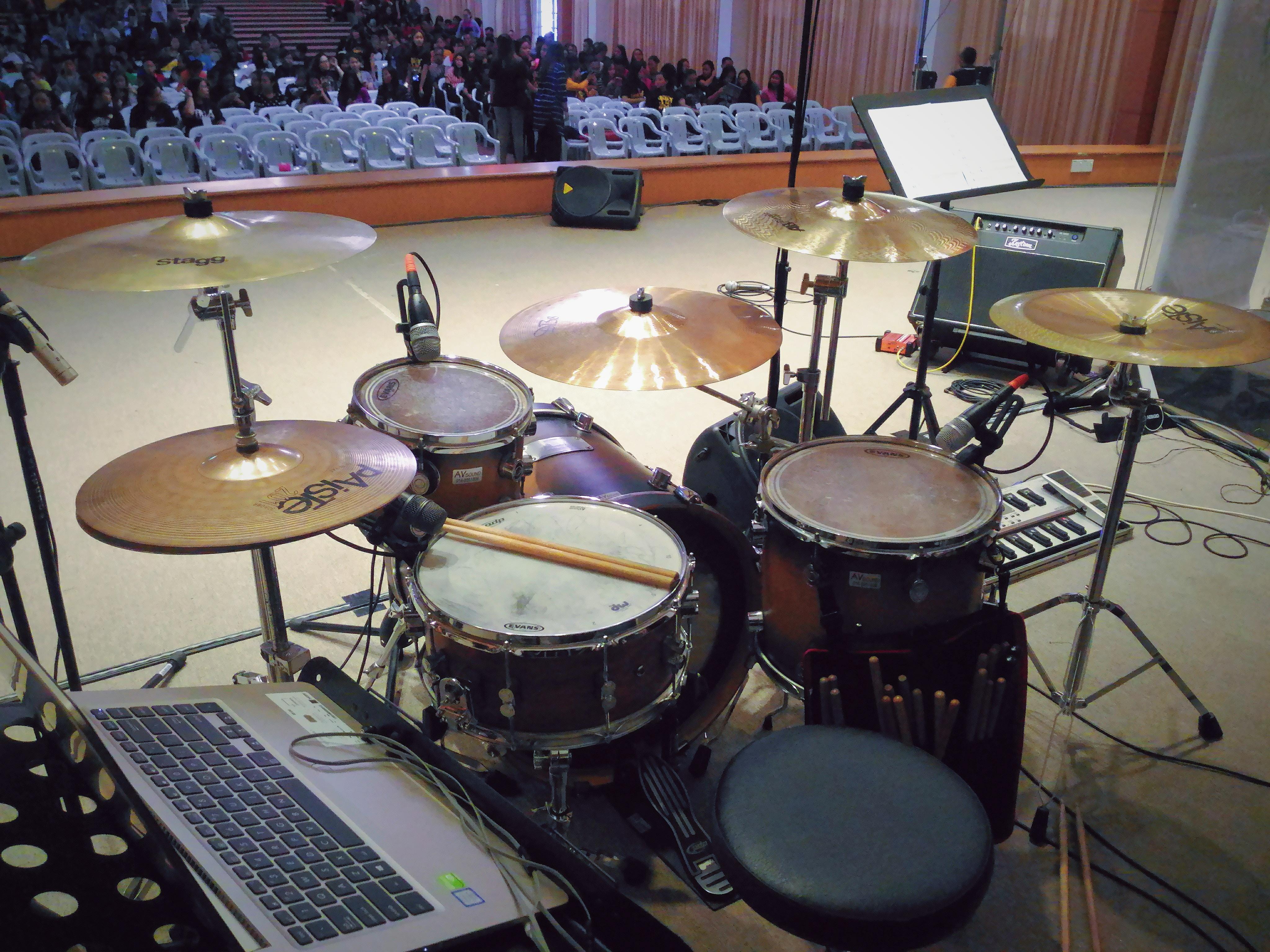 Drum set sitting on a stage.