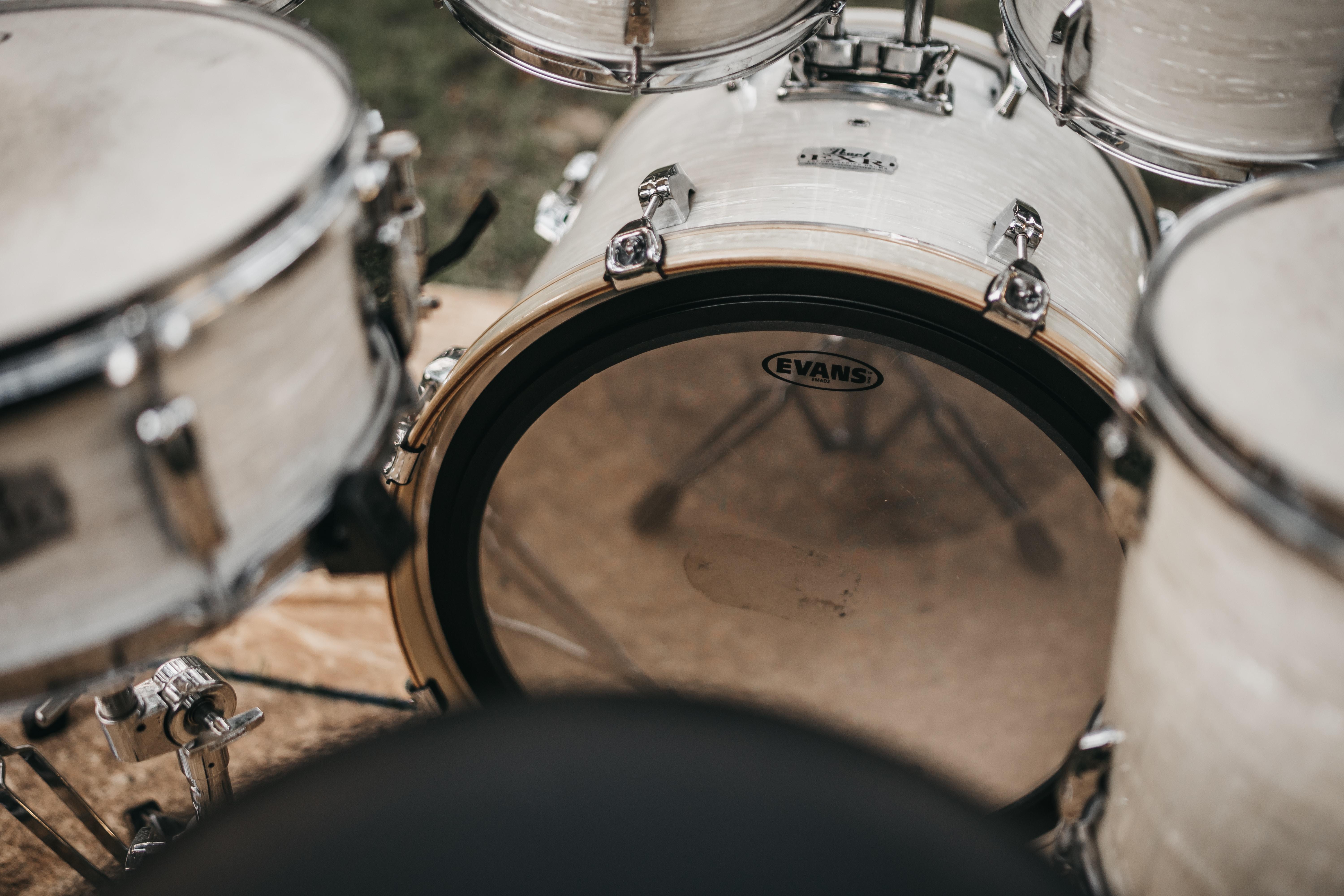 White drums sitting on the floor.