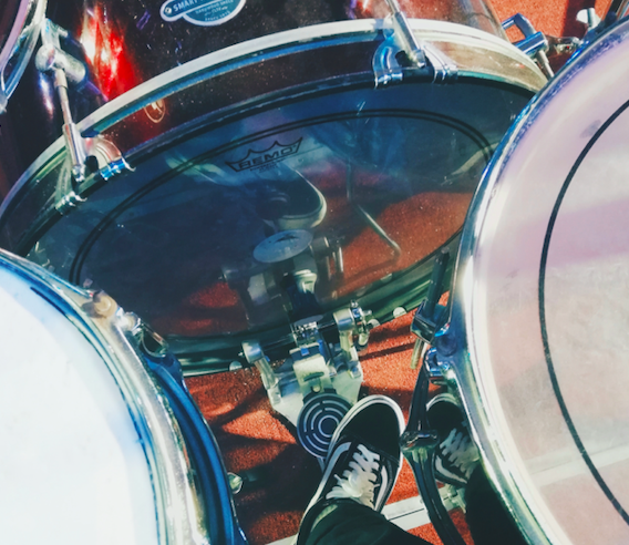 Person stepping on a bass drum pedal.