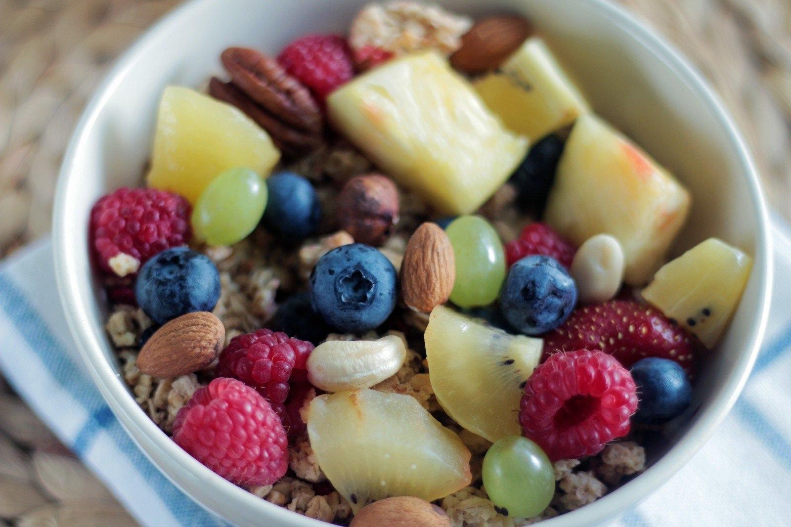 fruit bowl with berries, pineapple, grapes and nuts