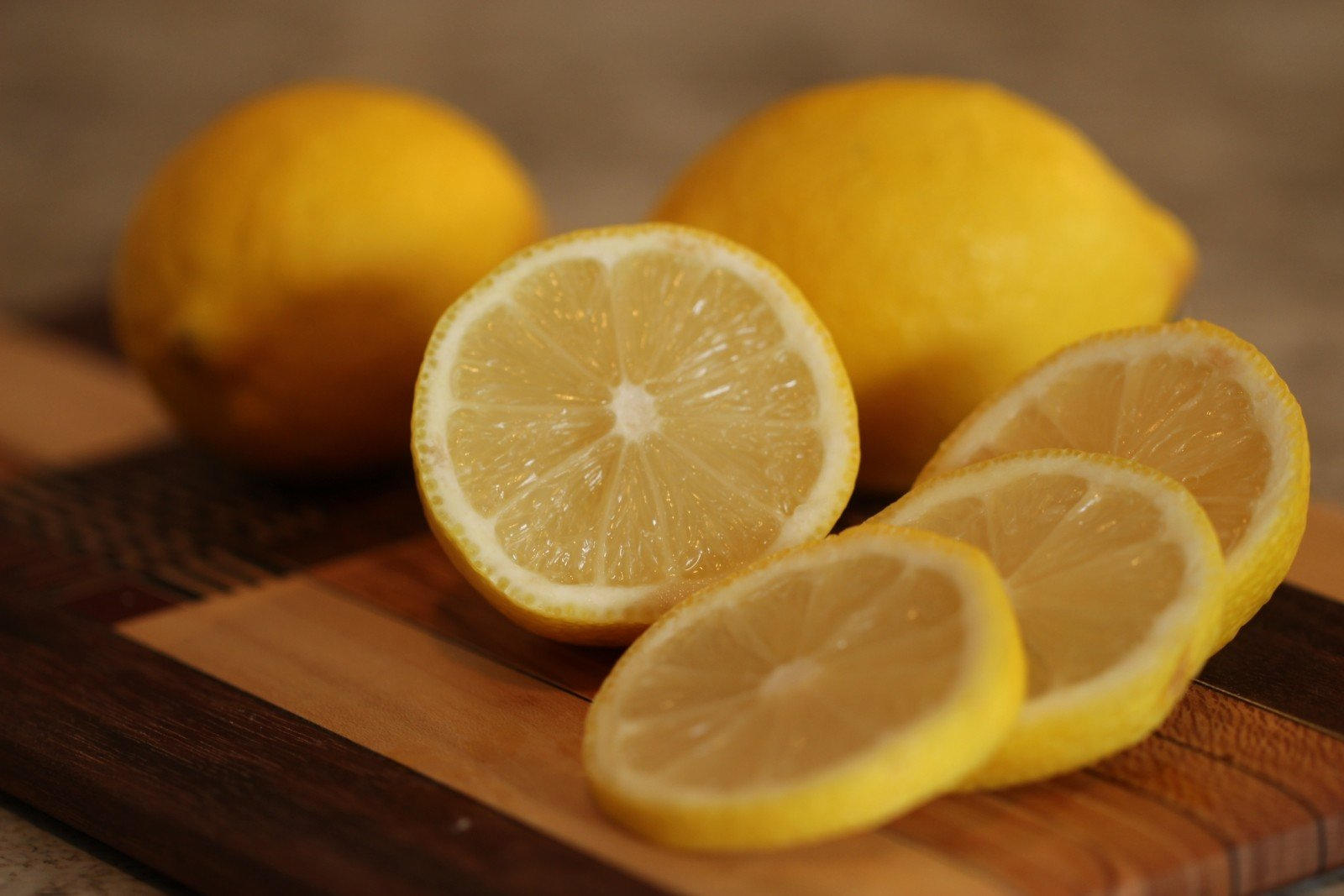 Fresh lemon cut up on cutting board