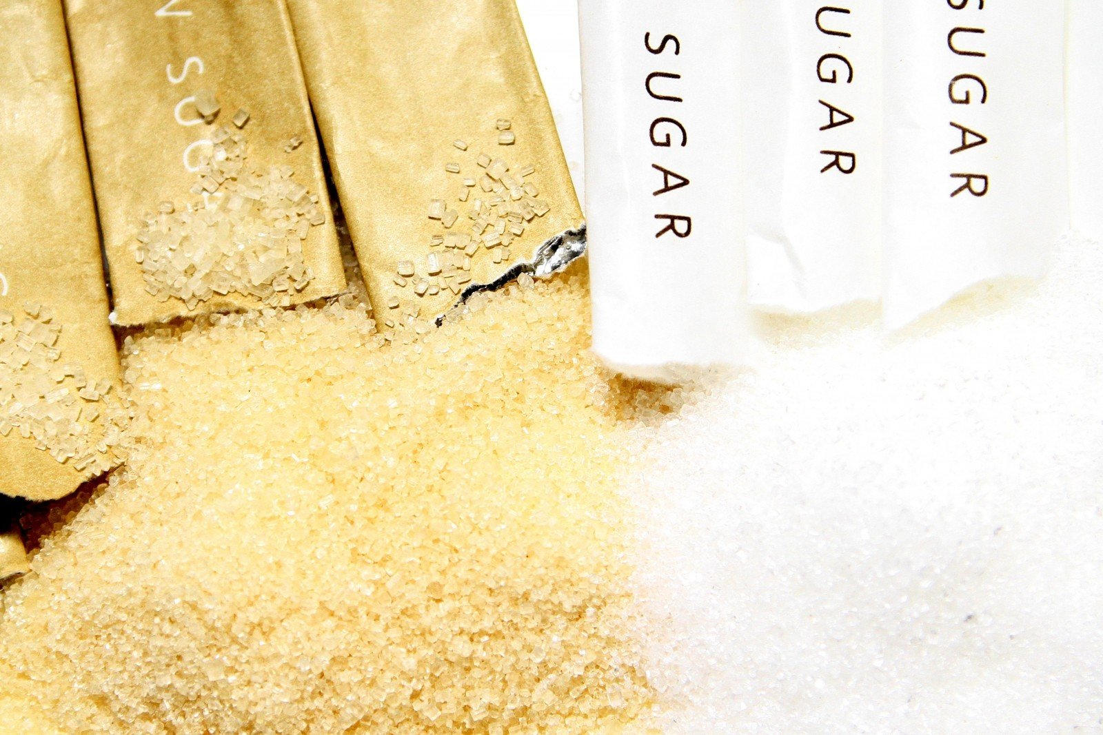 Open brown and white sugar packets