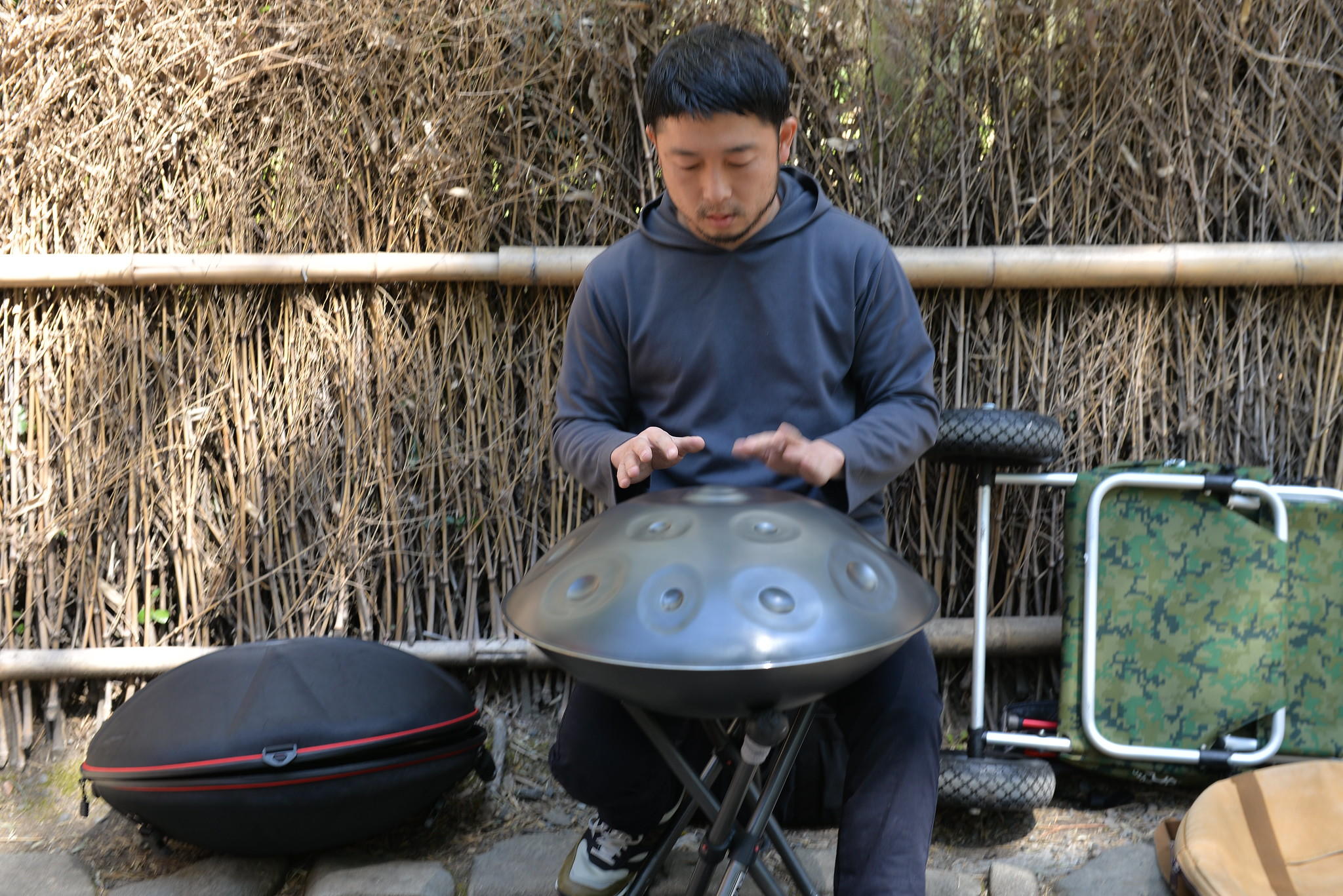 A man playing the steel hand drum