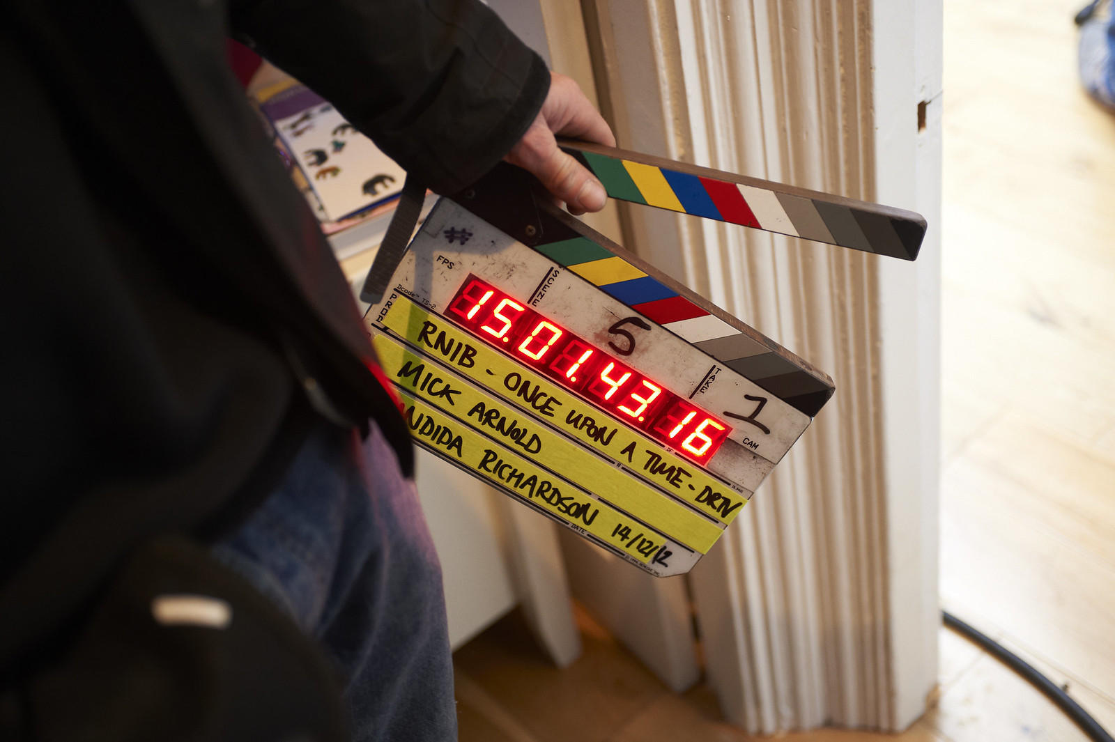 Guy holding a clapper board while filming