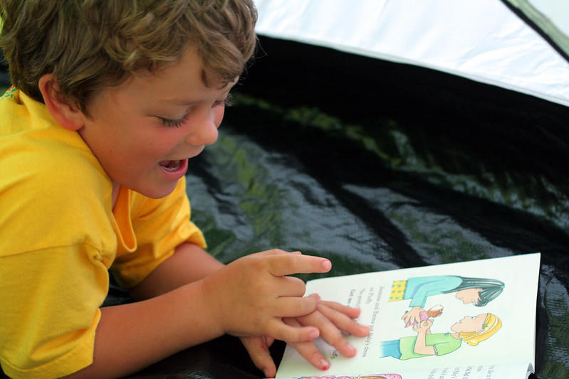 An elementary school child reading a book