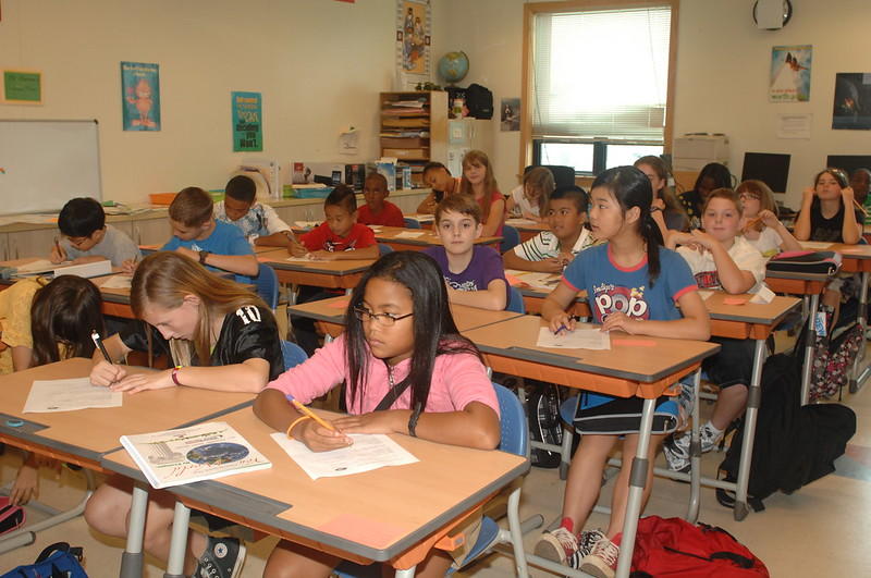Students of elementary school sitting in a classroom