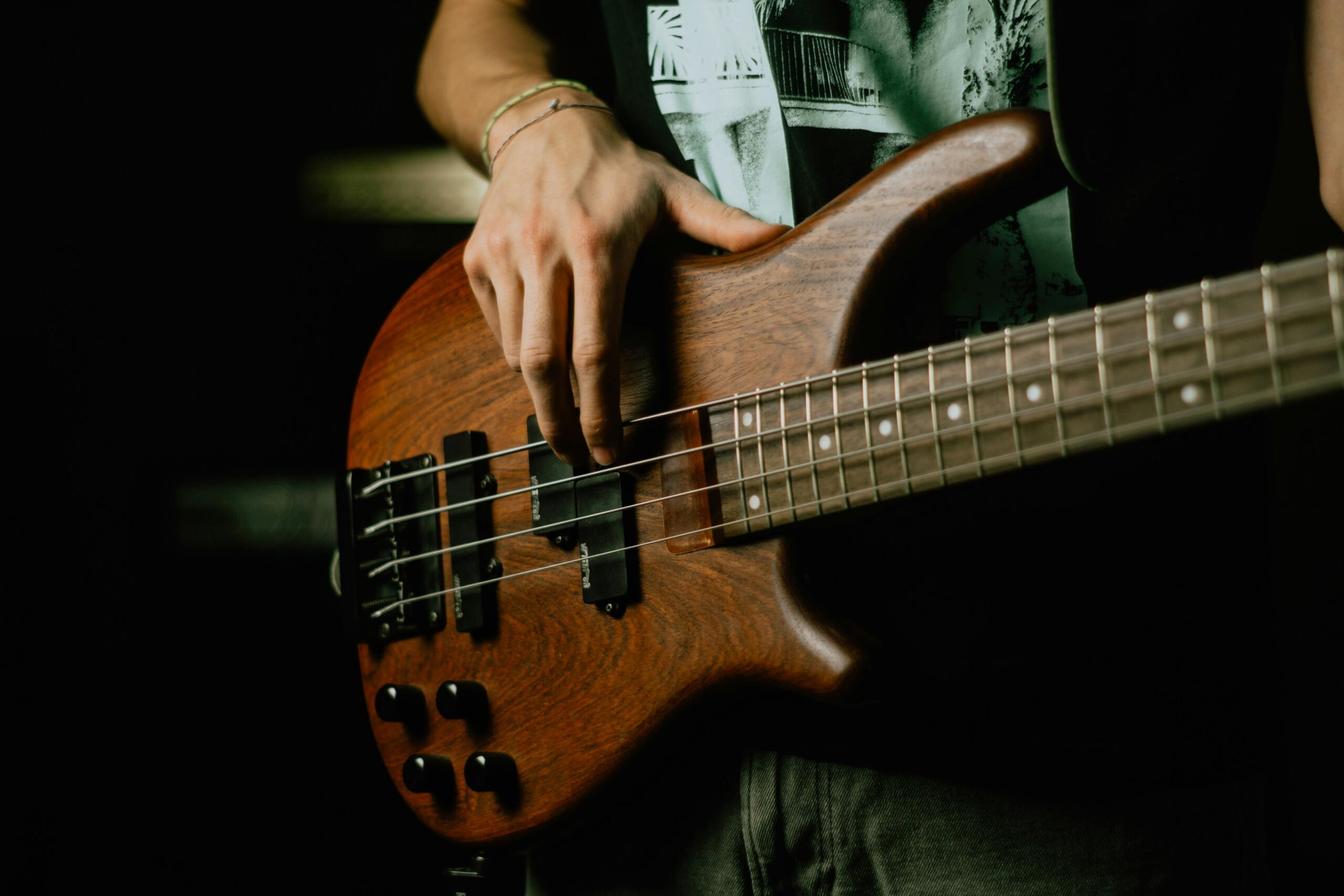 A bass player playing a wooden bass.