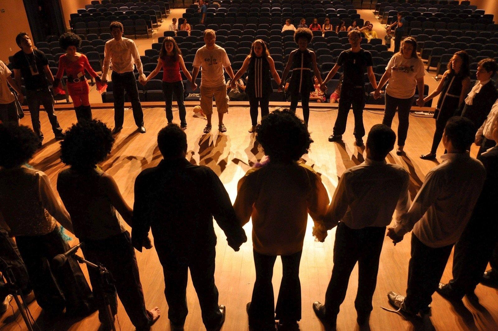 group of people on stage practicing scenes
