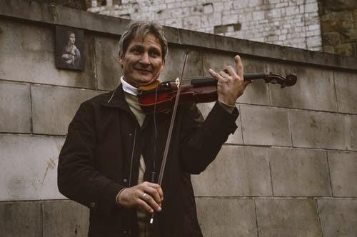 Man playing the violin as part of a group
