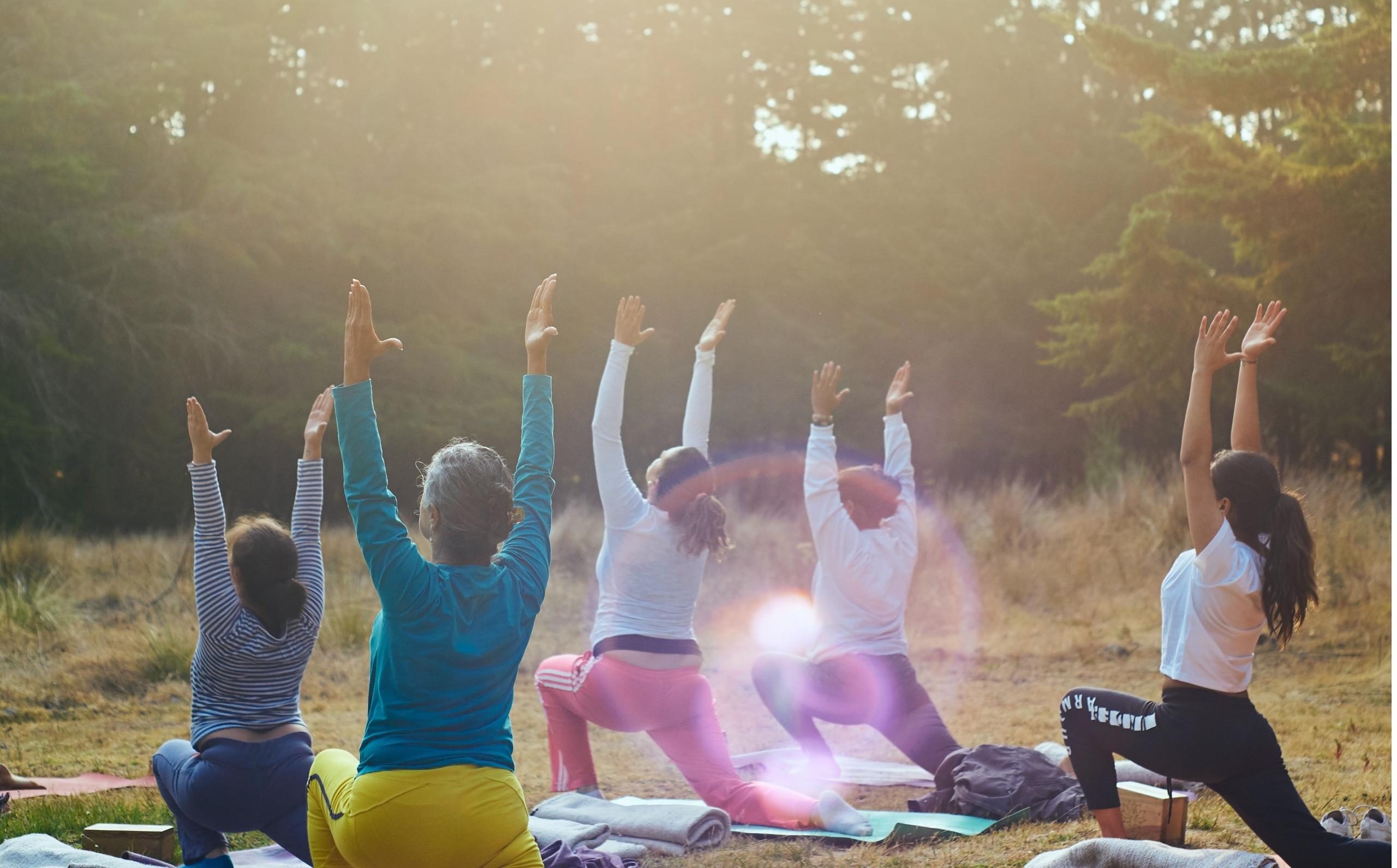 A yoga class for women taking place outdoors