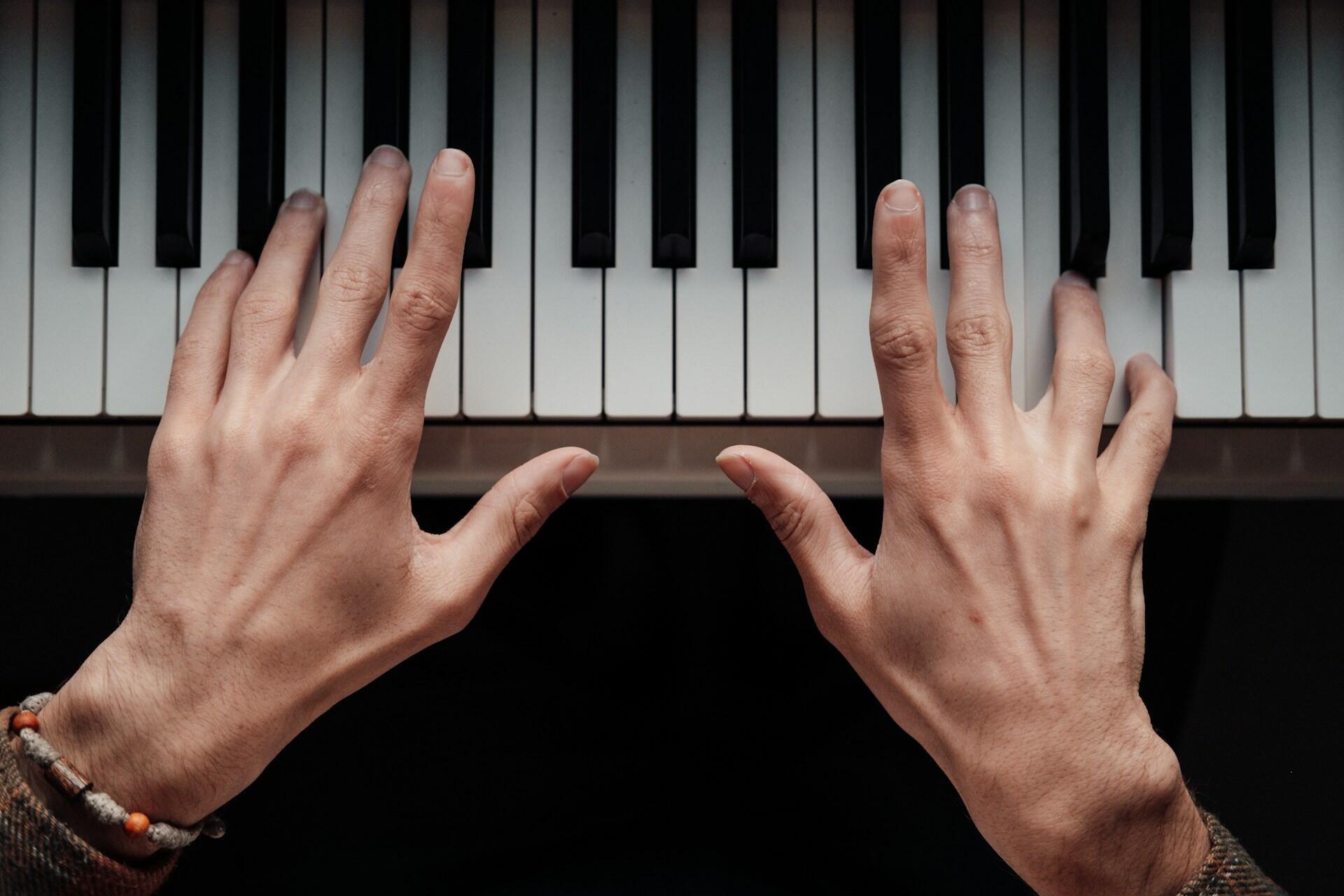 Hands playing on a keyboard.