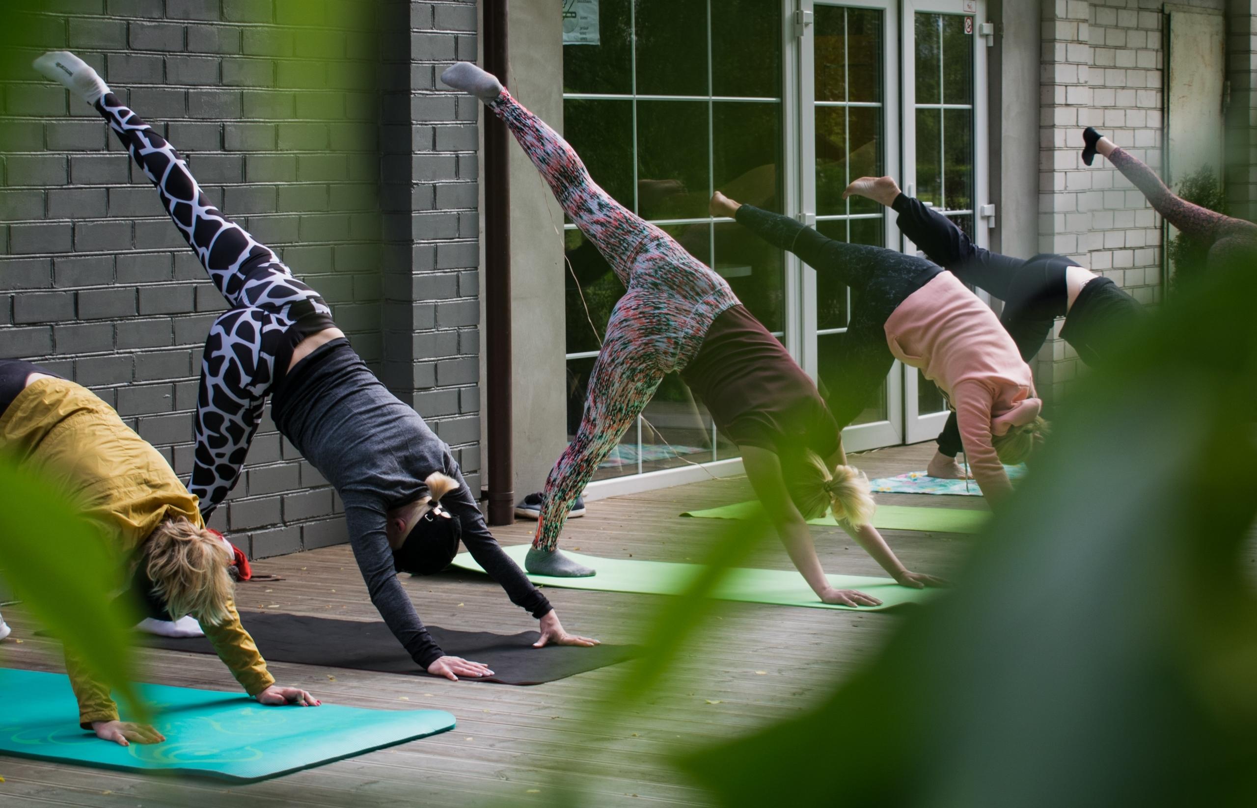 A group of people practicing yoga outdoors