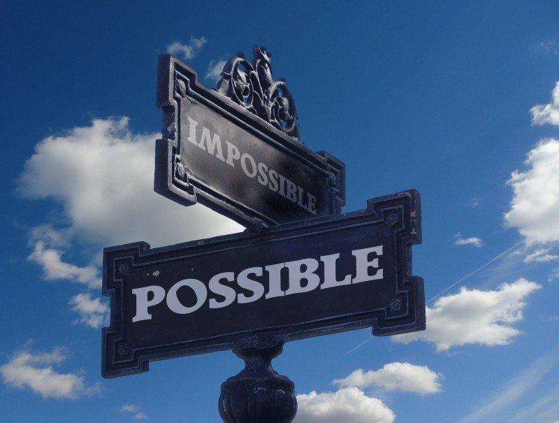A street signs reads possible & impossible. 