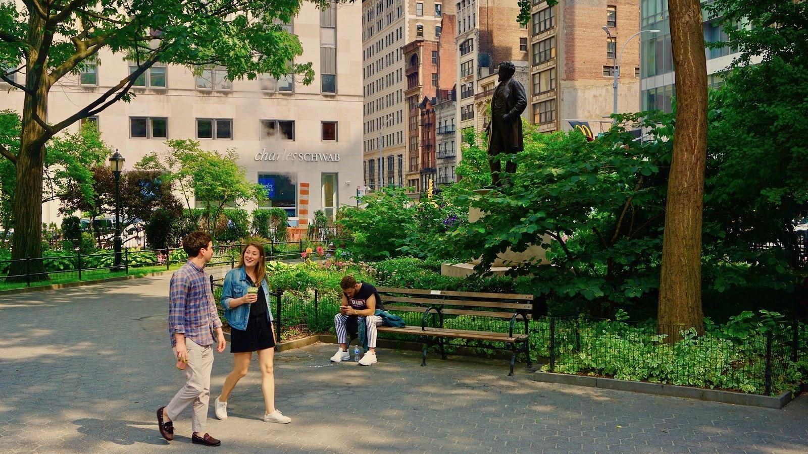 Two people walking in a park and talking during the day