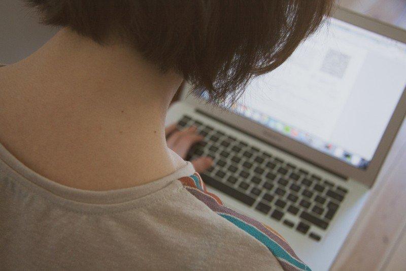 A young woman searches online.