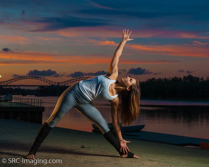 A yoga instructor stands in pose