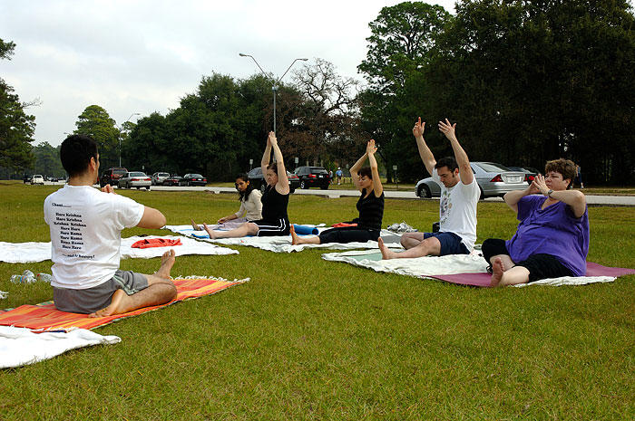 A yoga class takes place in a local park. 