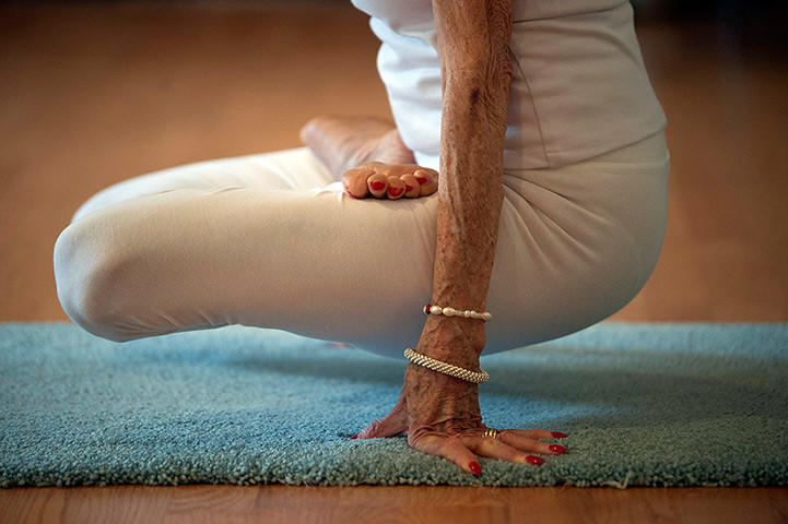 A trained yoga instructor engages in a pose.
