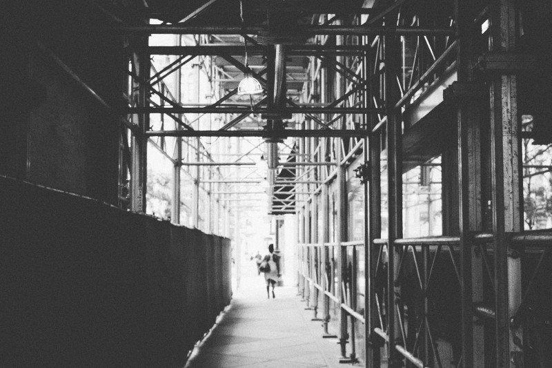 A woman walks beyond an underpass in Philly. 