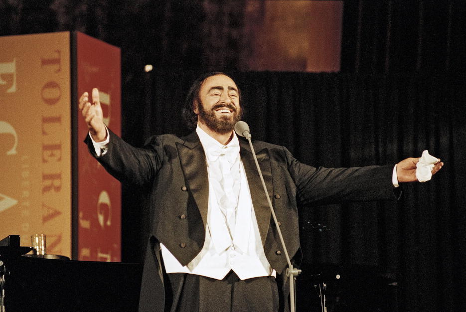 Luciano Pavarotti performing on stage.