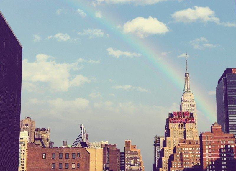 A rainbow peers across the city.
