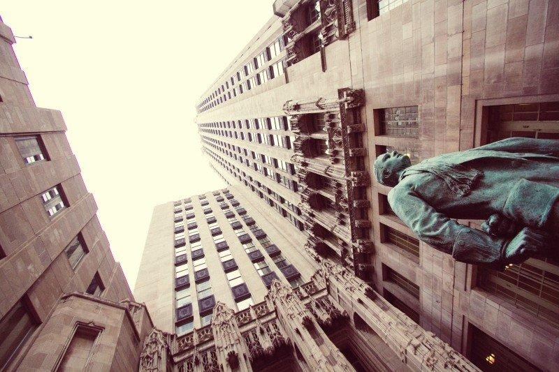 A statue amongst tall buildings