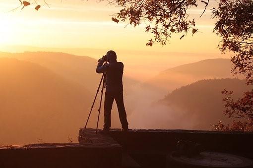 photography teacher setting the camera on a tripod