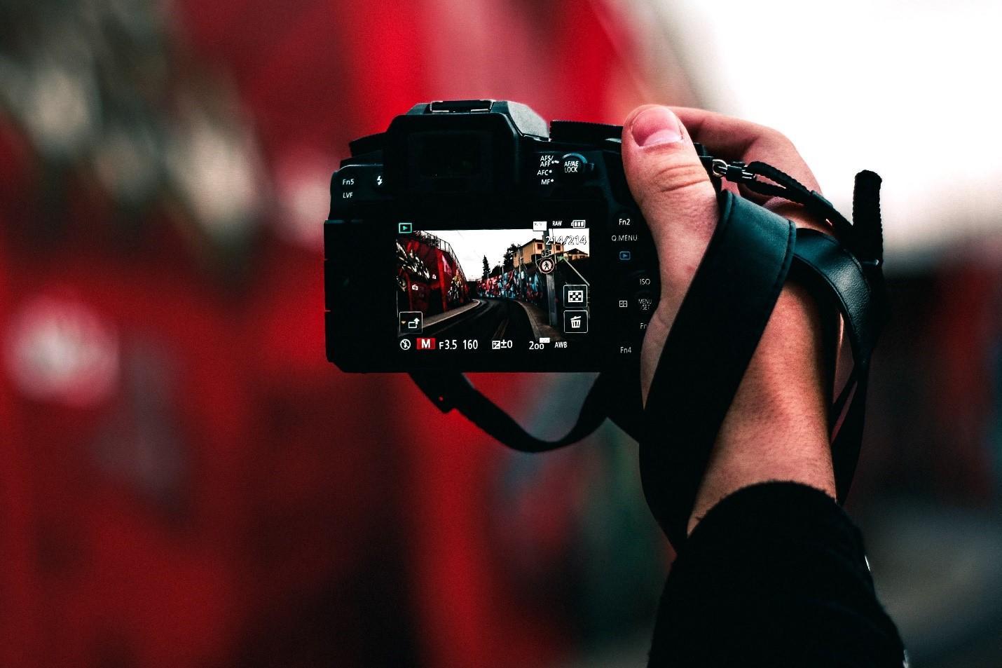 A student focusing on an object in a photography class