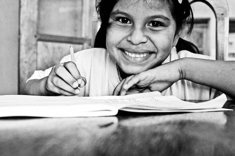 A child works through an English textbook.