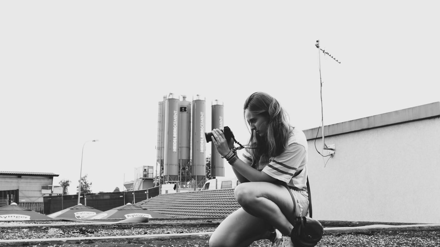 A female student practicing photography outside