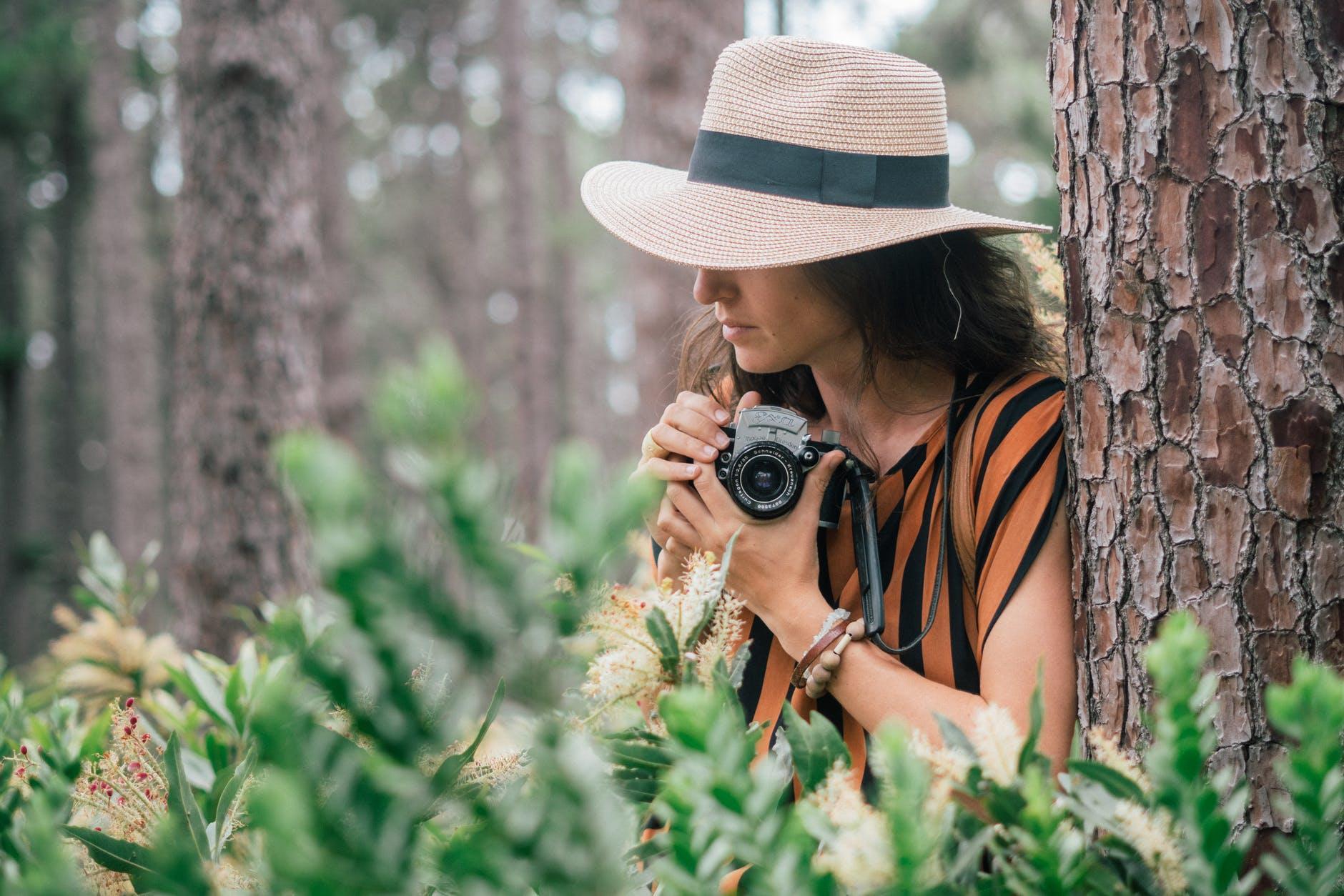 Female student capturing nature in an outdoor photography class