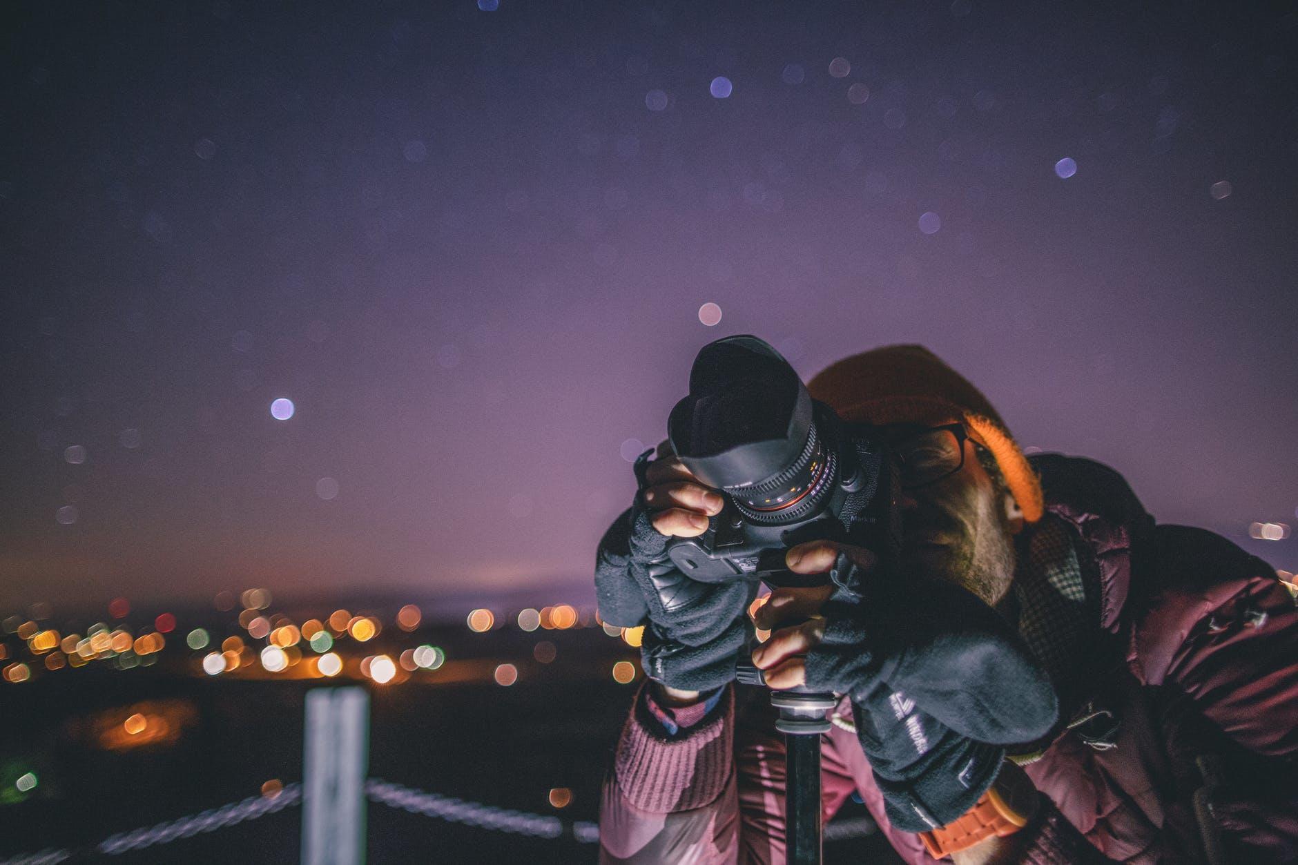 student taking a shot of the sky in an outdoor photography lesson