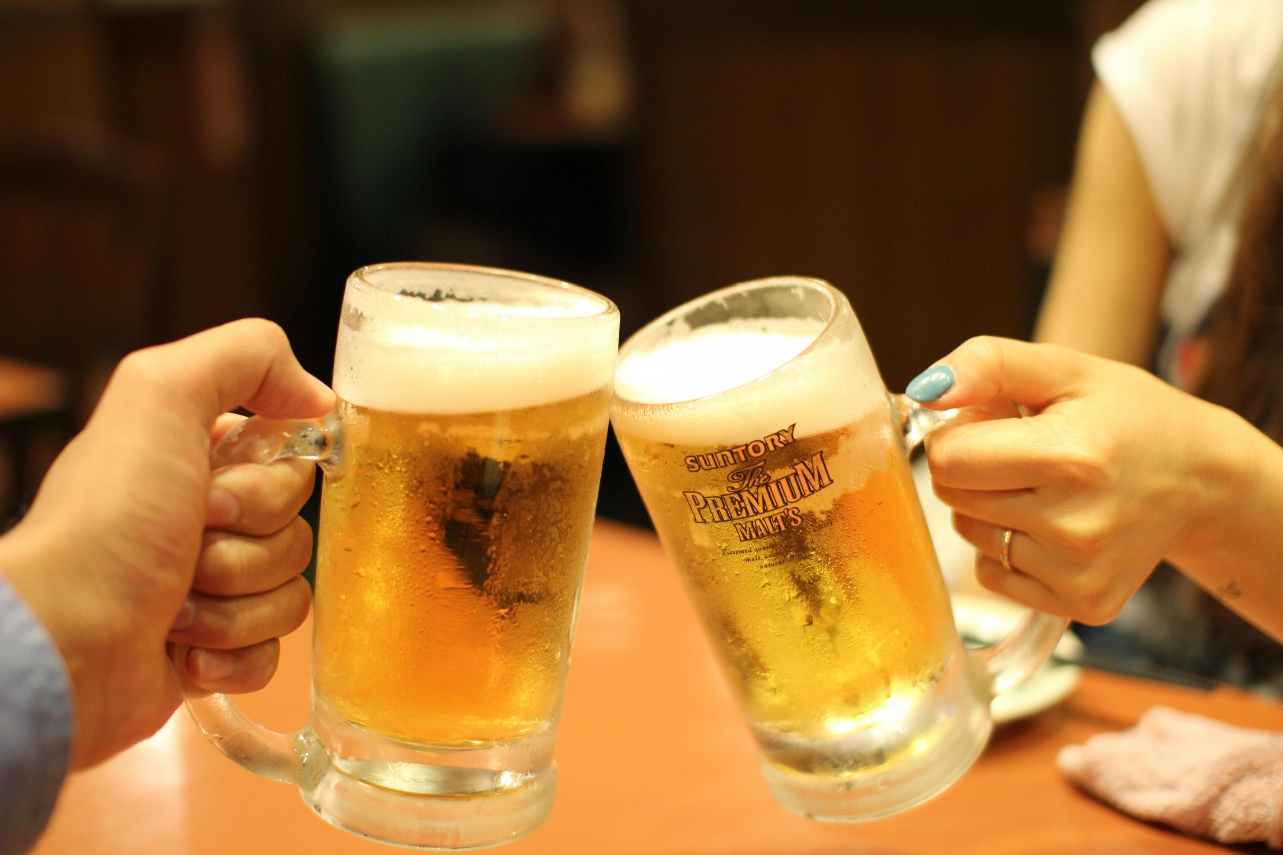 People cheering with two pints of beer for Germany's Oktoberfest