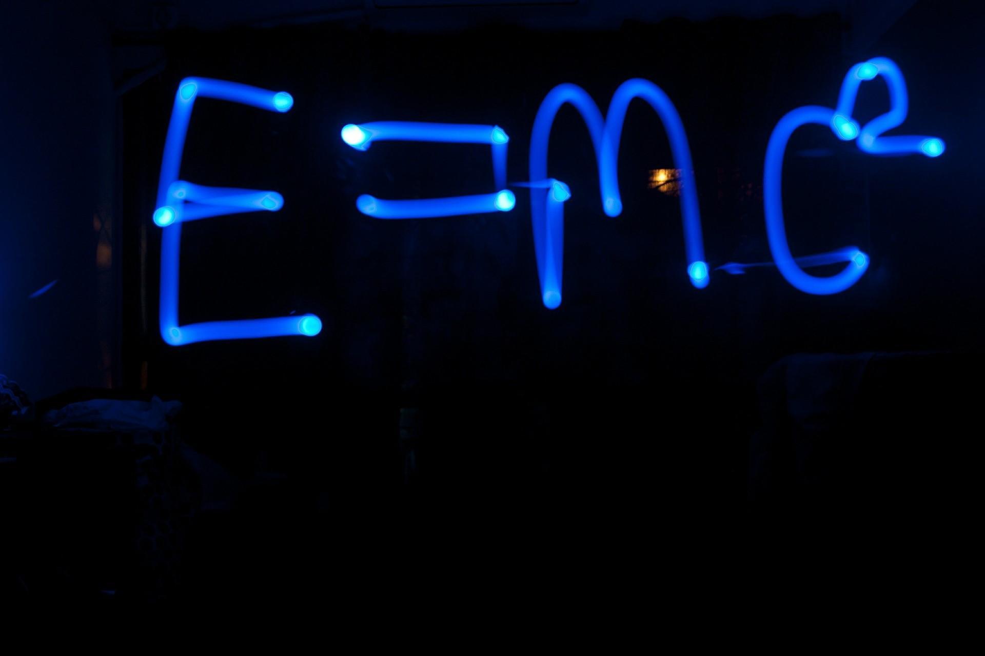 Einstein's E=mc2 formula written in glowing light, in a dark room. A good math tutor will make sure to take mind-boggling concepts and make them easy to understand in a series of fun and informative sessions