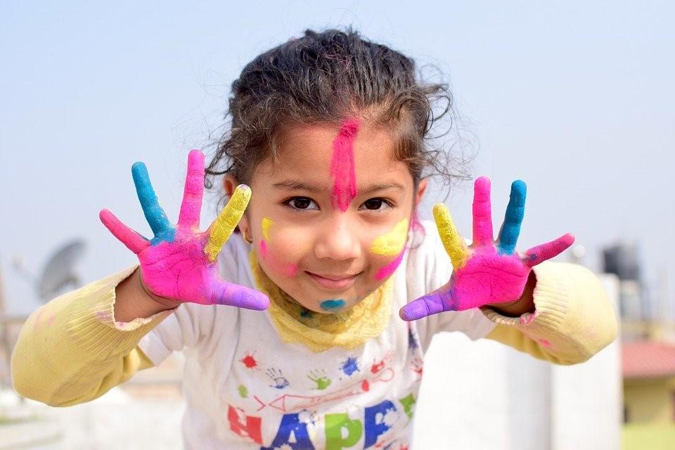 A child covered in paint.