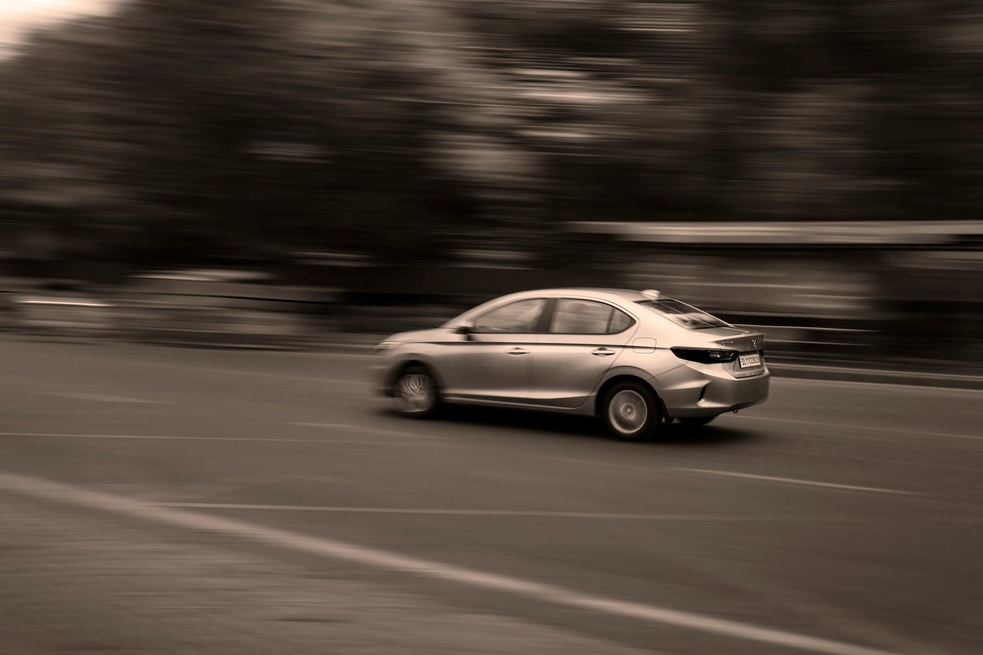 A blurred sepia photo of a car.