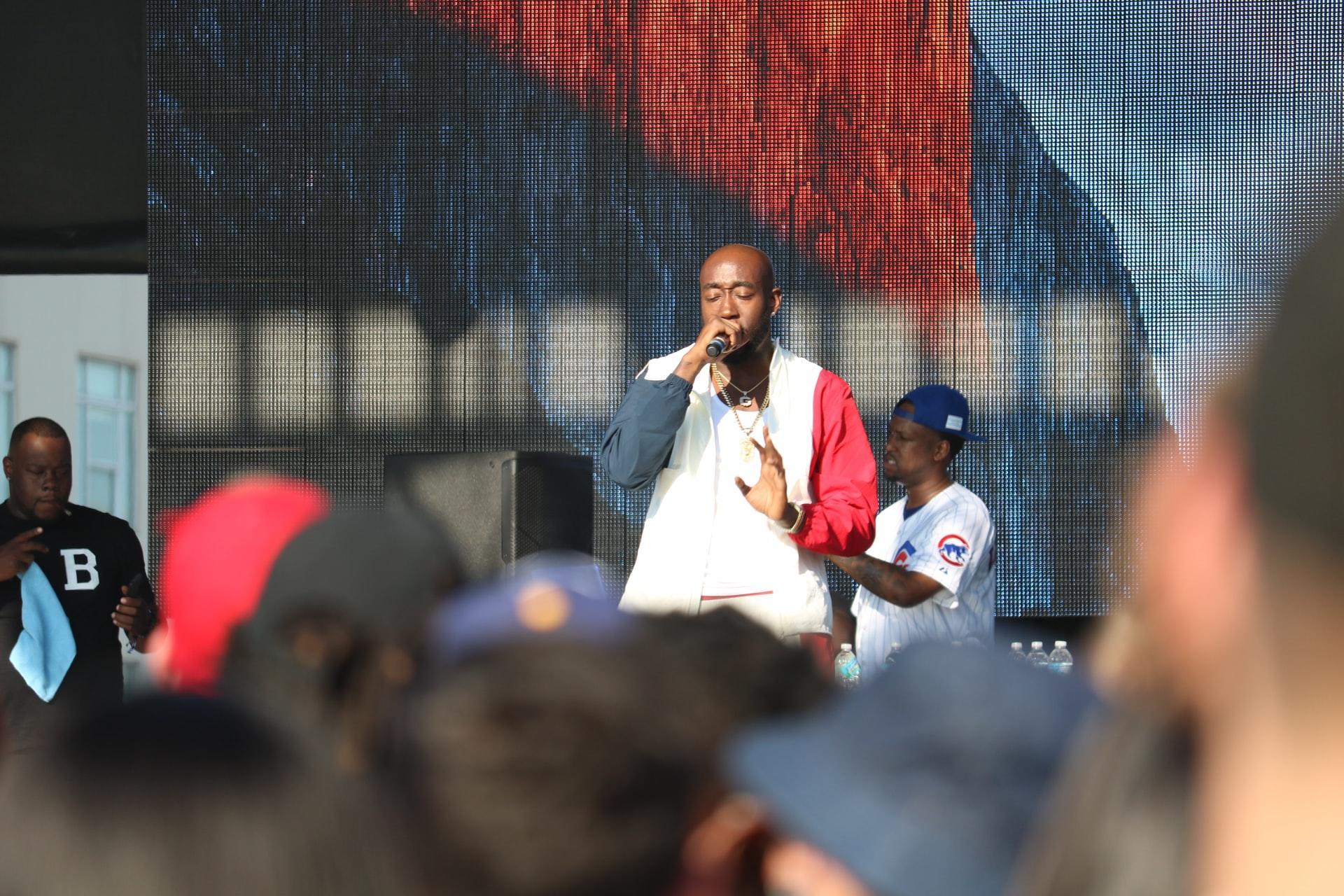 man singing on stage in front of a crowd