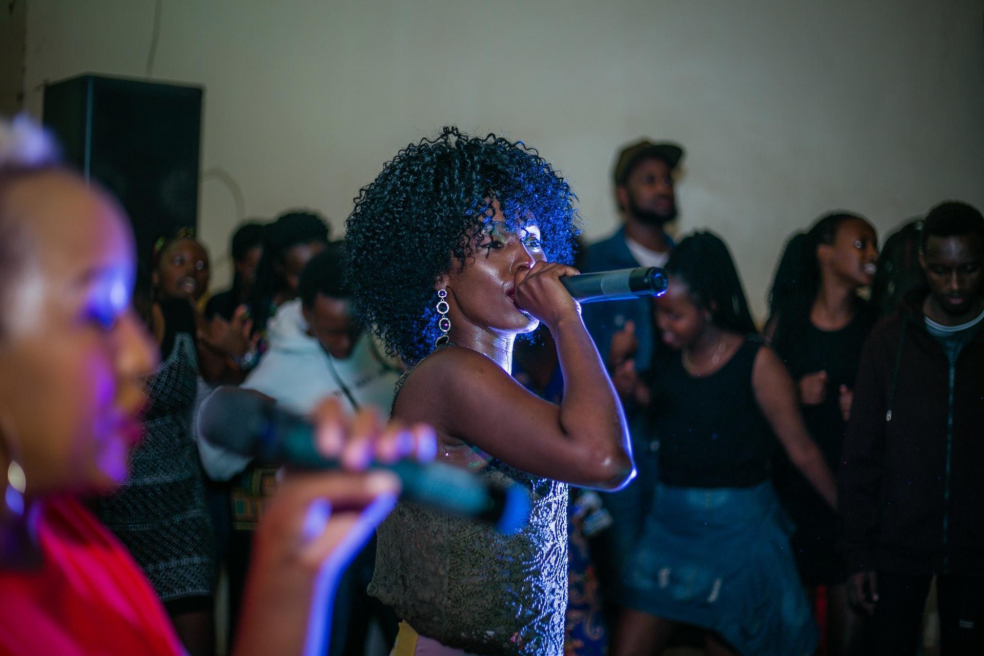 woman singing with a crowd of others