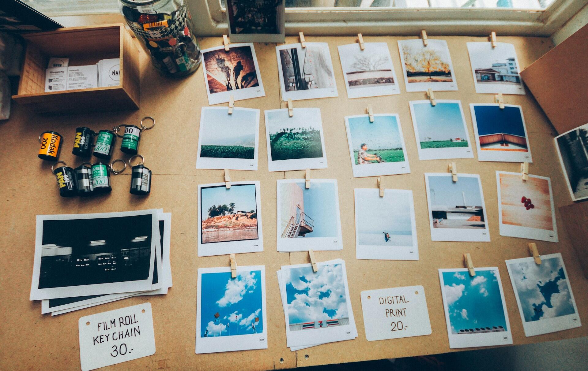 Film photos organized on a wooden table.