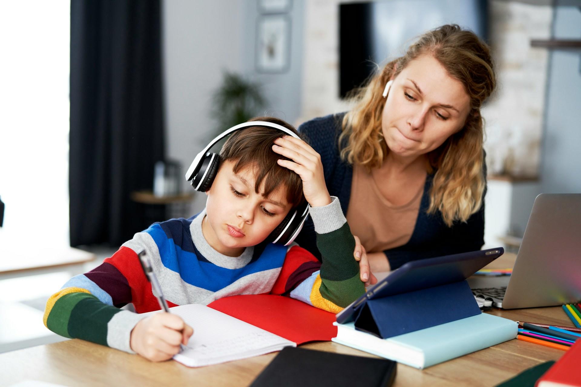 A boy doing his homework during a tutoring session.