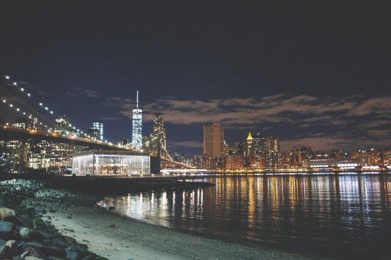 Seashore and cityscape at night.