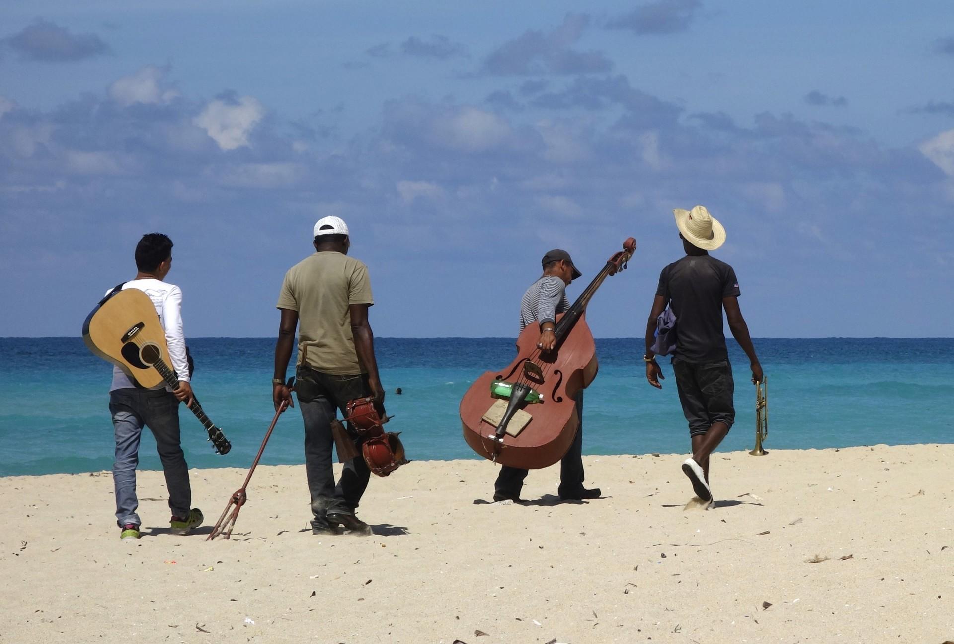 Musicians walking on the beach
