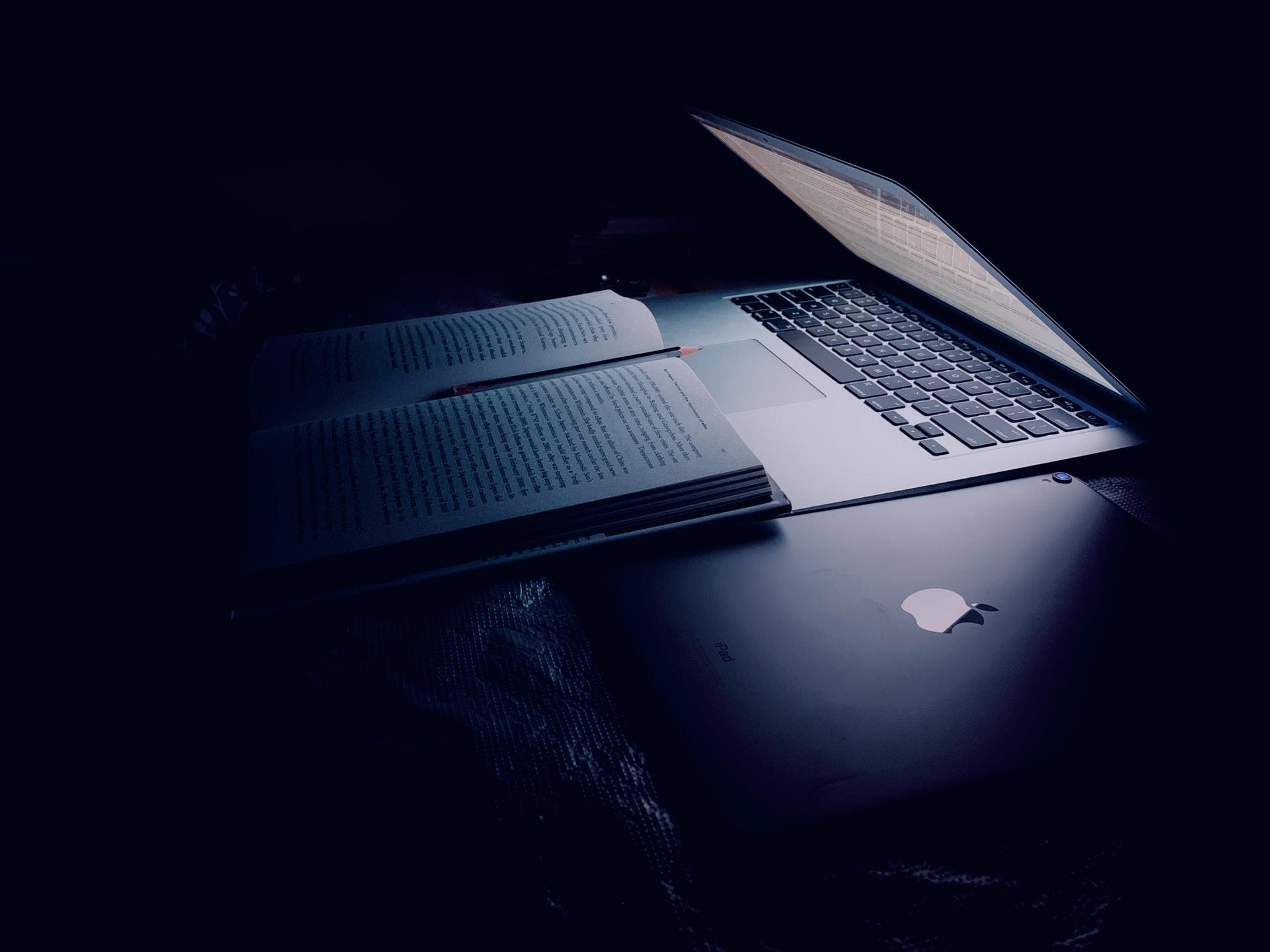 Styudy books in front of a laptop