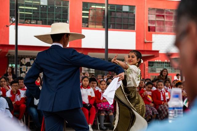 Man and woman dancing together in front of a crowd