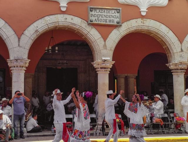 Men and women dancing in white.