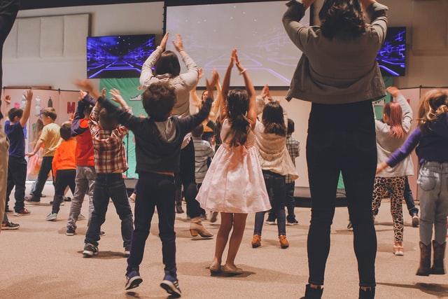 Group of kids dancing in a gym.
