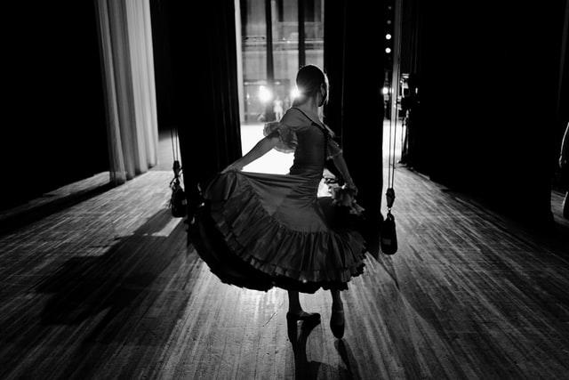 Women in a dress getting ready to go out on stage