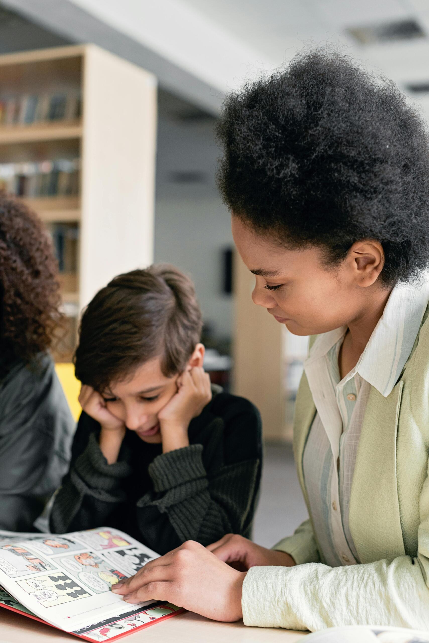 A private tutor is giving her student extra support in the classroom