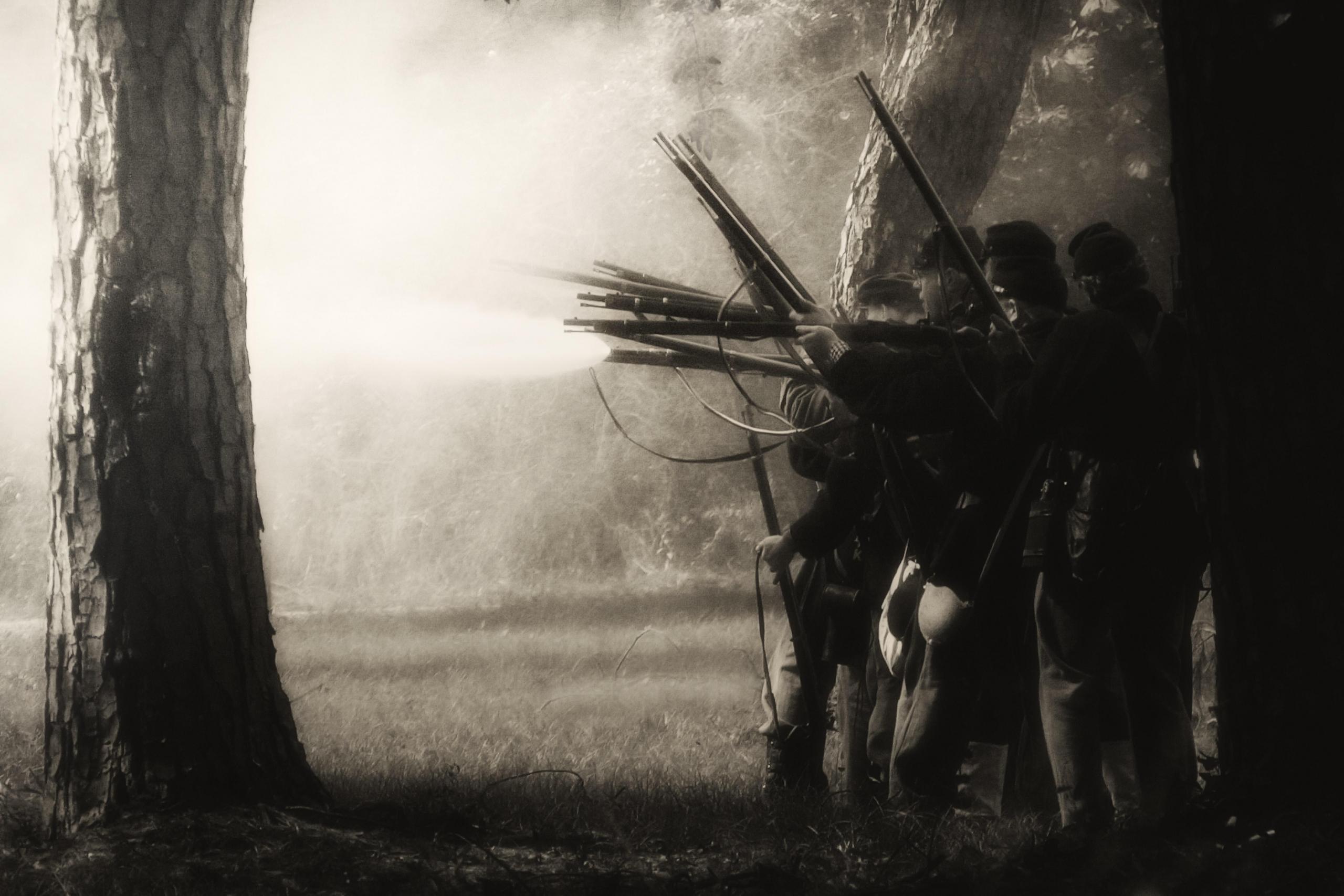 A band of people seen firing at the opponents during the American Civil War fought between 1861 and 1865. Muskets and revolvers were the most commonly found weapons during the war; while the North had caches, the South was severely under-armed