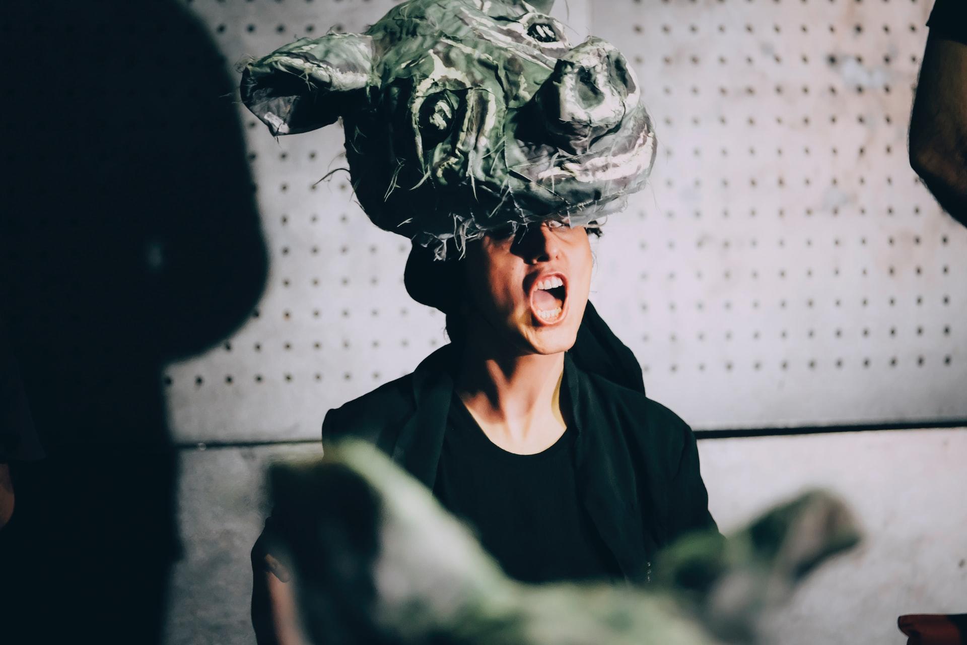 woman wearing a pig with mouth open singing